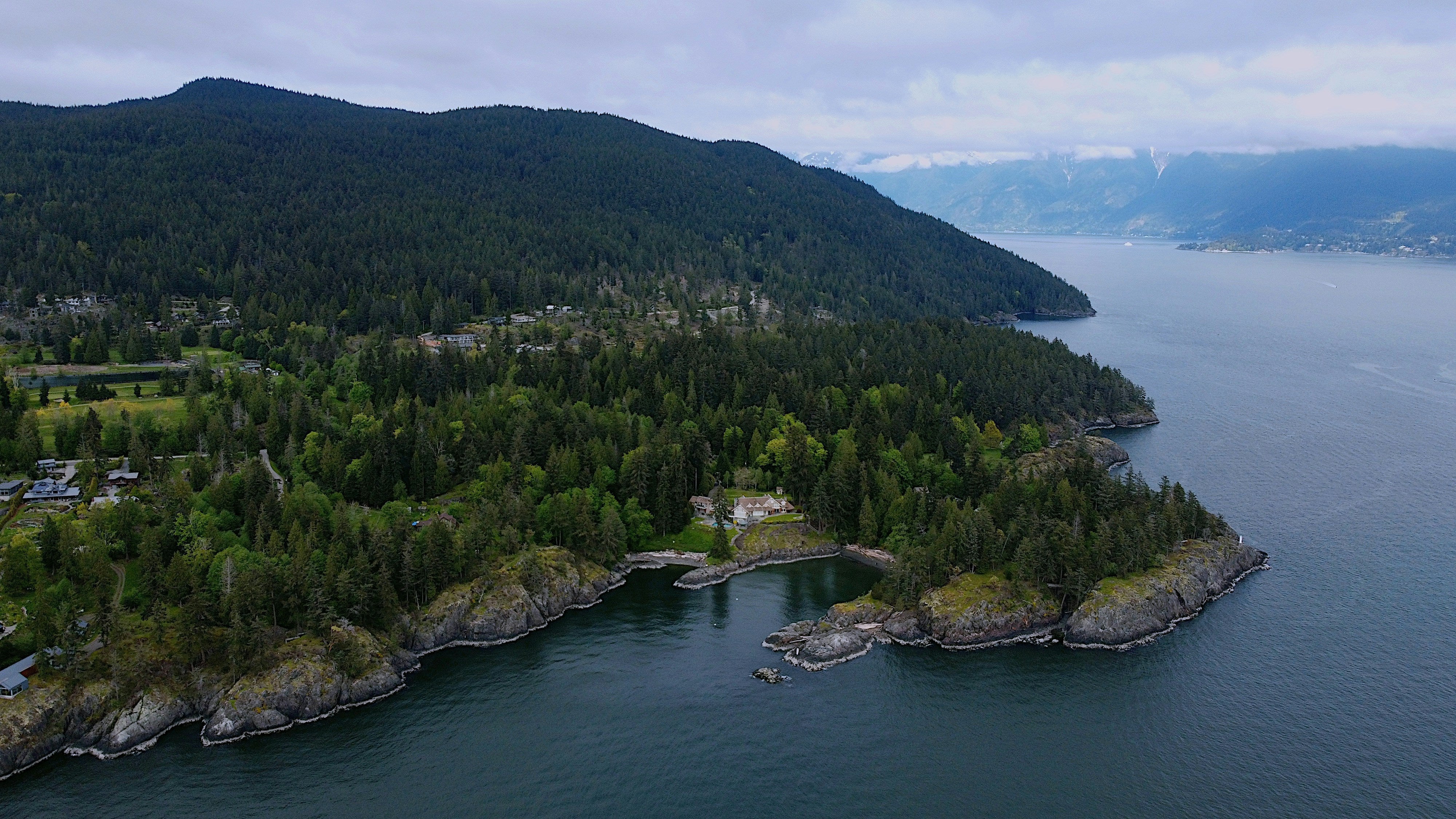 A piece of an island with water around it.