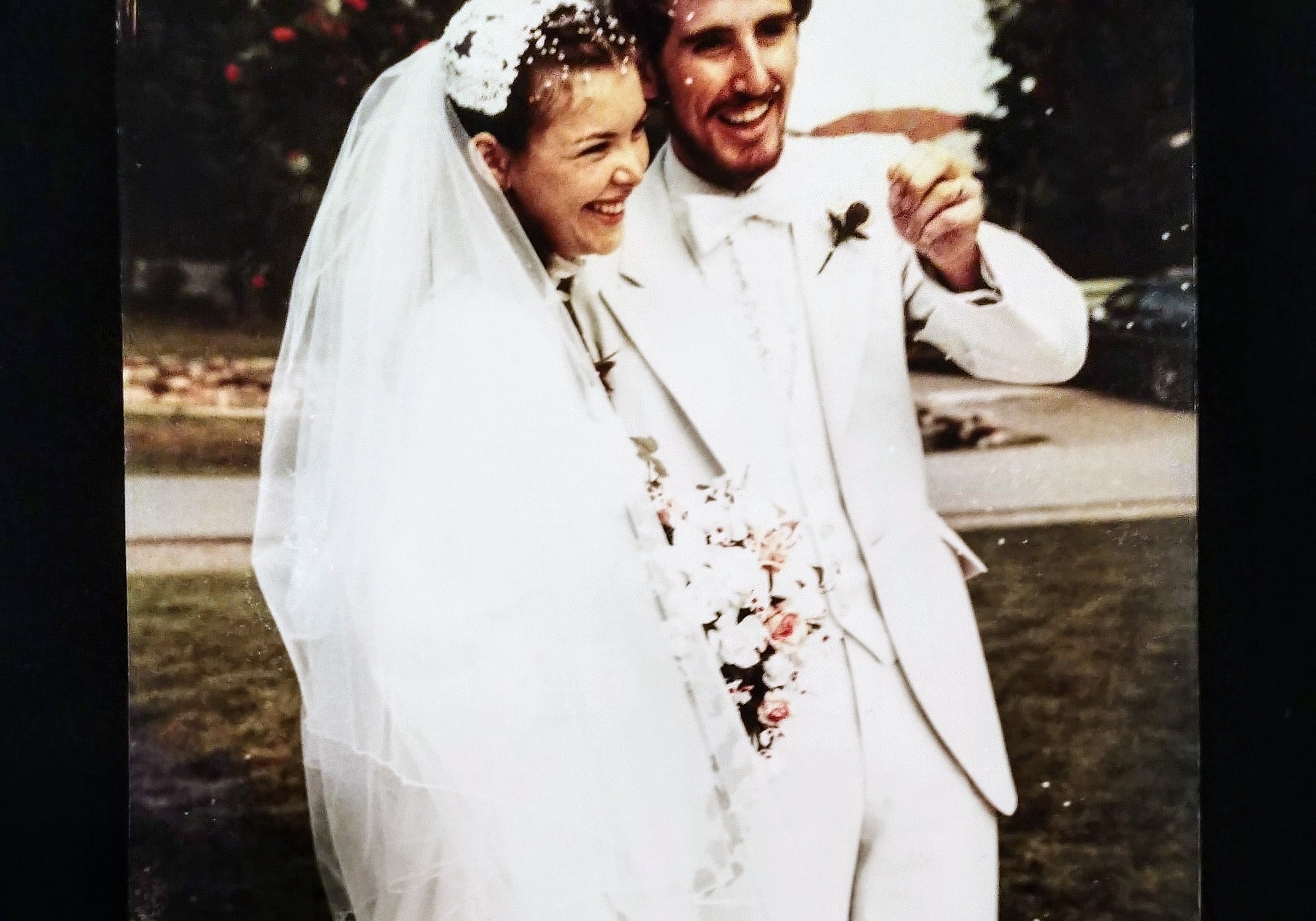Wedding couple posing outdoors with a blurred background