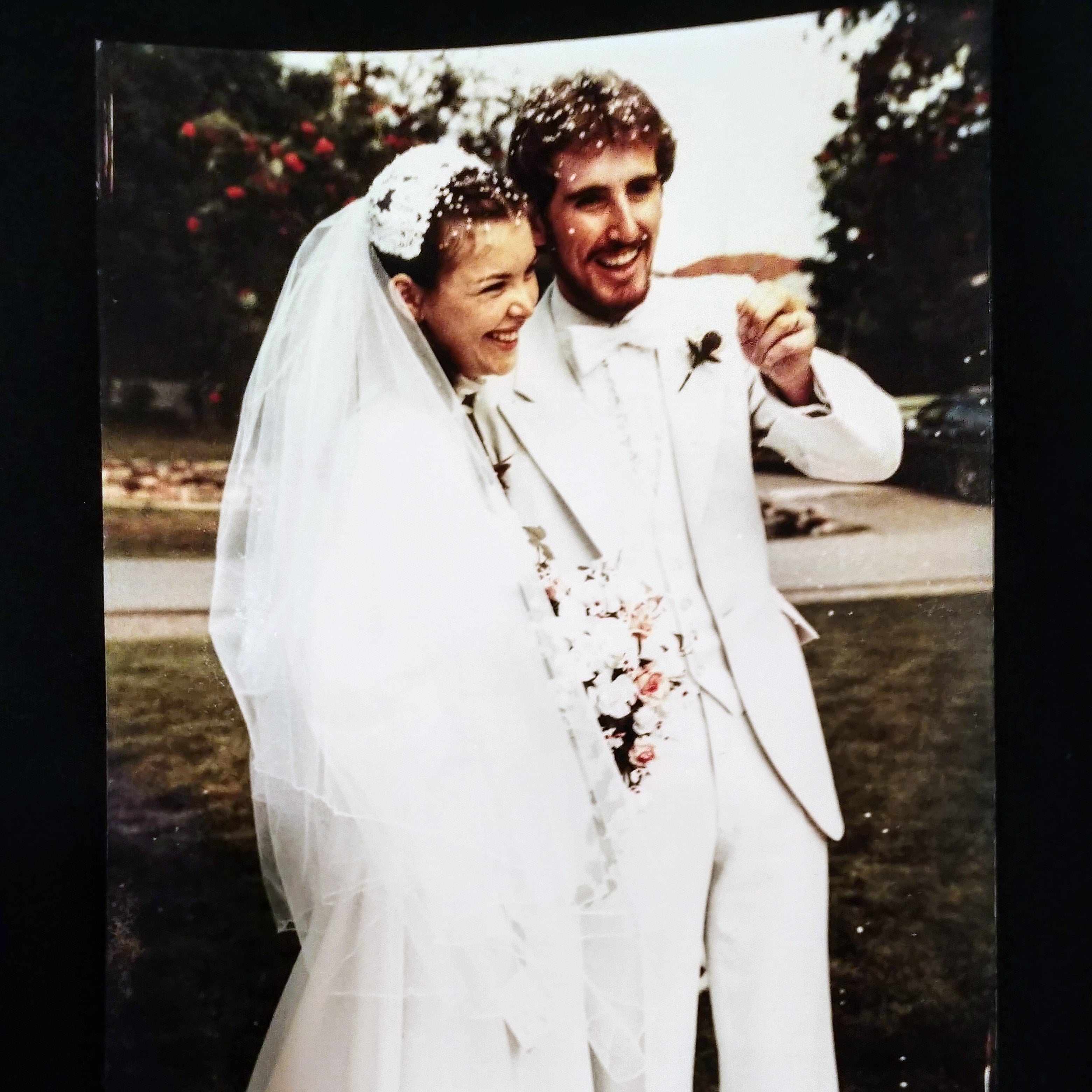 Wedding couple posing outdoors with a blurred background